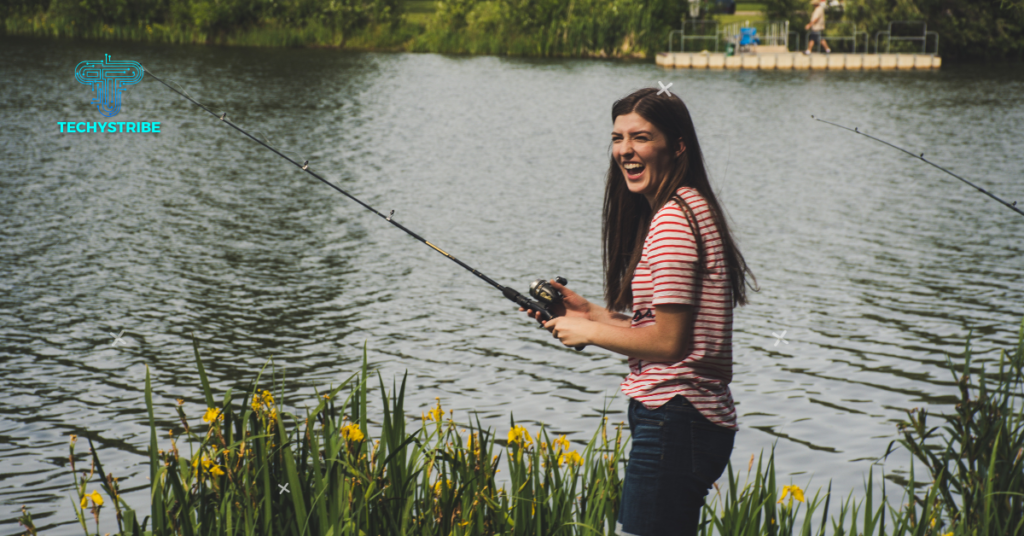 a portrait of woman fiskning near a lake